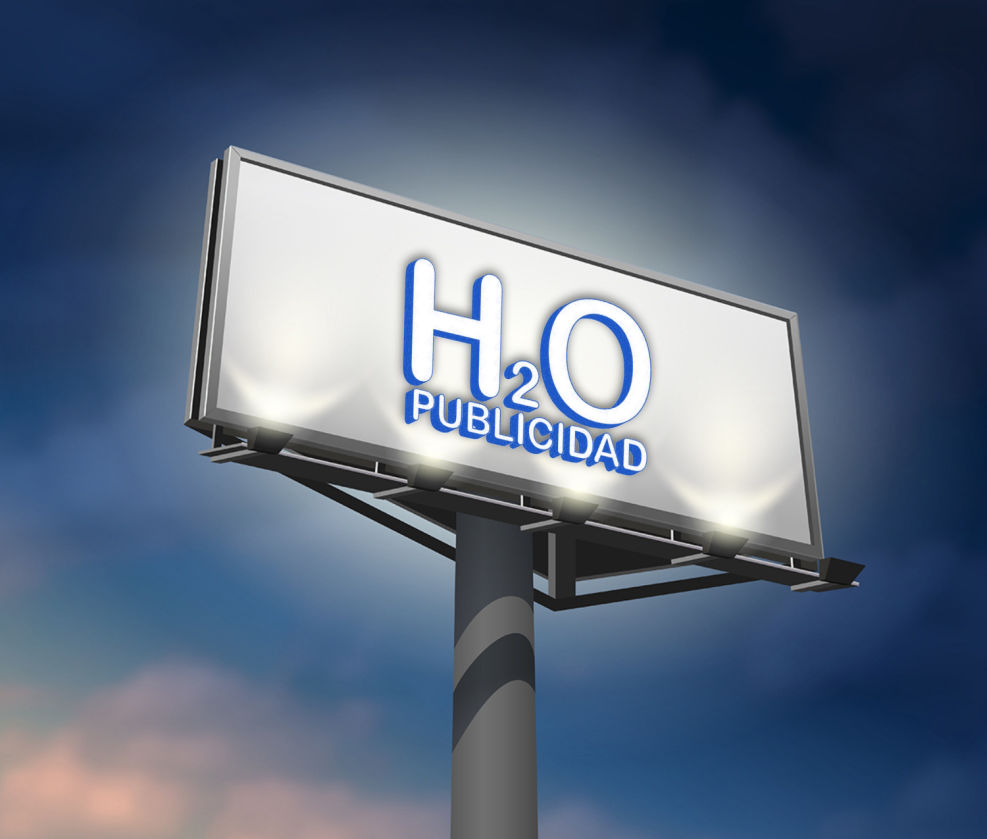 La imagen muestra un monoposte publicitario con un diseño moderno y llamativo. En la parte superior, hay un cartel con fondo blanco que exhibe el texto “H₂O PUBLICIDAD” en letras grandes y tridimensionales de color azul con un efecto iluminado.  El cartel está montado sobre una estructura metálica robusta, con un poste cilíndrico de gran tamaño que lo sostiene a una altura considerable. En la parte inferior del cartel, se pueden ver focos de iluminación dirigidos hacia el anuncio, lo que resalta aún más el mensaje, especialmente en horarios nocturnos.  El fondo muestra un cielo azul con algunas variaciones de color, lo que sugiere un ambiente despejado y da protagonismo al cartel. La perspectiva de la imagen está ligeramente inclinada desde abajo hacia arriba, enfatizando la altura e impacto visual del monoposte.